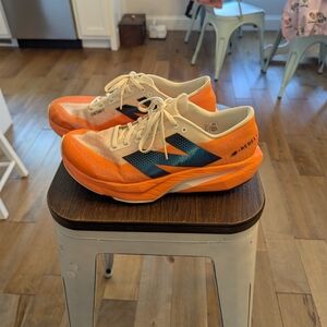 New Balance Orange and Cream Fuel Cell Rebel V4 Running Shoes